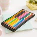 Bicolor Triangular Colour Pencils Pack of 12 (24 Shades)pencil colorsCRAFTY CUDDLESet of colored pencils in a case on a light blue notebook with a white backgroundcolouring pencils coloring supplies kids coloring tools art materials school art supplies colour pencil set color pencil pack student stationery