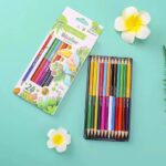 Set of colored pencils with packaging on a light blue background