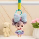 Cute Mini Doll Keychain for GirlsKeychainsCRAFTY CUDDLEDoll keychain with large bow and checkered dress hanging from a bar with a soft backgroundBlue Bow DollDollKeychain CuteAccessories GirlsAccessories BagCharm ReturnGiftIdeas KidsFashion KawaiiStyle PrincessTheme BirthdayReturnGift MiniDoll