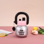 Stainless Steel Wide Mouth Water BottleTumblersCRAFTY CUDDLESilver water bottle with pink top and black handle on a pink background with flowers and citrus slices.SilverStainlessSteelBottle WideMouthBottle InfuserBottle ReusableStraw TravelWaterBottle GymWaterBottle LeakproofBottle DetoxWaterBottle PortableBottle EcoFriendlyLifestyle