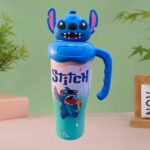 Kids Cartoon Stainless Steel Insulated Sipper BottleTumblersCRAFTY CUDDLEBlue character - themed tumbler with a handle on a green backgroundBlue StitchKidsWaterBottle CartoonBottle StainlessSteelBottle 1000mlBottle SchoolWaterBottle SipperBottle LeakproofBottle KidsEssentials BackToSchool ReusableBottle