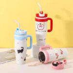 1000ml Stainless Steel Insulated TumblerTumblersCRAFTY CUDDLEThree colorful water bottles with handles and straws on a yellow backgroundSky BlueInsulatedTumbler StainlessSteelMug TravelTumbler 1000mlBottle VacuumFlask HotAndColdBottle BPAFree CoffeeOnTheGo CarCupHolderFriendly ReusableDrinkware