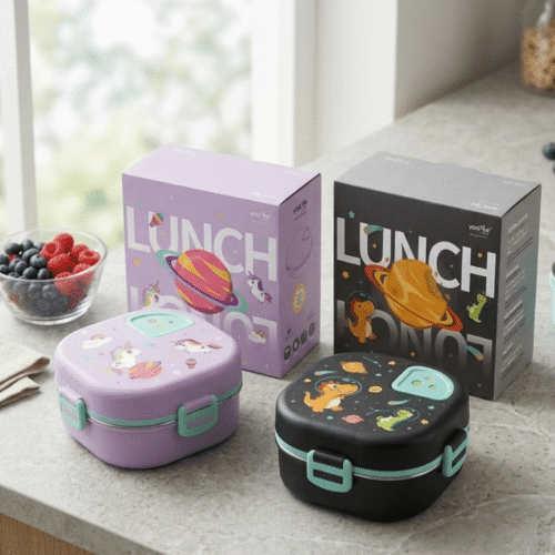 Two lunch boxes, one purple and one black with cartoon designs, on a surface with a 'Lunch' box in the background.