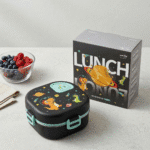 Kids Cartoon Stainless Steel Bento Lunch BoxStainless Steel Lunch BoxCrafty CuddleBlack lunch box with space - themed design next to its packaging on a light surface.Greykidslunchbox bentolunchbox schoollunch kidslunch lunchboxforkids cartoonlunchbox unicornlunchbox dinosaurlunchbox schoolessentials kidsproducts