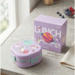 Kids Cartoon Stainless Steel Bento Lunch BoxStainless Steel Lunch BoxCrafty CuddlePurple lunch box with unicorn design next to its packaging on a table.Purplekidslunchbox bentolunchbox schoollunch kidslunch lunchboxforkids cartoonlunchbox unicornlunchbox dinosaurlunchbox schoolessentials kidsproducts