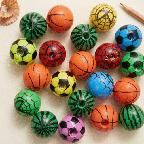 Colorful pencil sharpeners shaped like sports balls on a light background