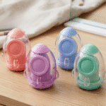Four colorful plastic sharpeners on a wooden surface