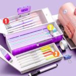 Dinosaur Passcode Pencil BoxDino theme pencil boxCRAFTY CUDDLEStationery set with pens, markers, and other office supplies on a purple backgroundBackToSchoolEssentialsCuteDinosaurs