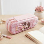 3D Cartoon Double Layer Pencil PouchPencil PouchCrafty CuddlePink pencil case with cartoon character on a wooden tablePinkpencilpouch 3dpencilcase kidsstationery doublelayerpencilcase cartoonpencilpouch schoolstationery stationeryforkids cutestationery backtoschool studentstationery