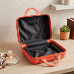 Mini Travel Organizer Case for KidsTravel BagsCrafty CuddleOrange makeup case on a wooden surface with a plant and perfume bottle in the backgroundOrangeKidsStorage MiniSuitcase KidsOrganizer ToyStorage StationeryOrganizer KidsTravelEssentials CuteStorageBox TravelOrganizer KidsAccessories KidsProducts