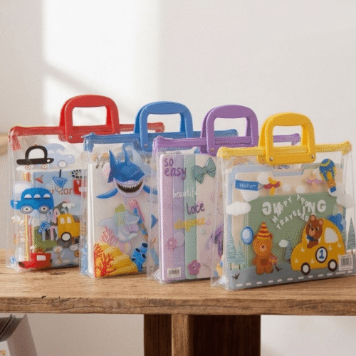 Four colorful children's bags with handles on a wooden surface.