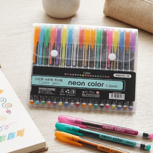 Pack of neon color pens with a few pens laid out on a surface.