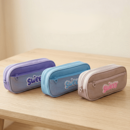 Three colorful pencil cases with 'sweet' text on a wooden surface.