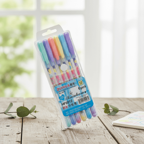 Pack of six colorful pens in a clear plastic package on a wooden surface with a blurred natural background.