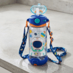Children's water bottle with space-themed design and colorful strap on a light gray surface
