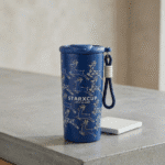 Leakproof Printed Water FlaskCartoon Kids Water BottleCrafty CuddleBlue tumbler with deer design and strap on a concrete surfaceBlueInsulatedBottle SteelWaterBottle SipperBottle LeakproofBottle TravelBottle HotColdBottle ReusableBottle DailyHydration OfficeEssentials EcoFriendlyBottle