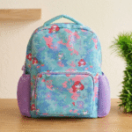 Space-themed pencil case on a wooden surface with a blurred background