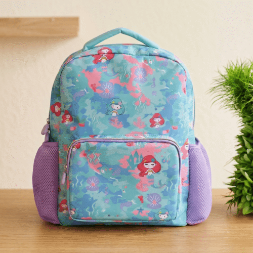 Backpack with mermaid pattern on a wooden surface