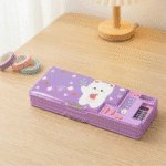 Smart Pencil Box with CalculatorPencil BoxCrafty CuddlePurple pencil case with cartoon design on a wooden tablePurplepencilbox kidsstationery multifunctionpencilbox cartoonpencilcase schoolstationery kidsstudyessentials stationeryforkids cutestationery backtoschool studentstationery