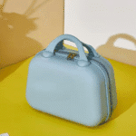 Hard Shell Multi - Purpose Travel Organizer CaseTravel BagsCrafty CuddleLight blue suitcase on a yellow surface with a neutral backgroundBlueTravelOrganizer MultipurposeOrganizer StorageCase TravelEssentials KidsOrganizer StationeryStorage MakeupOrganizer PortableOrganizer HardShellCase TravelStorage