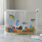 Transparent Cartoon Zipper PouchPencil PouchCrafty CuddleClear pouch with ocean - themed design featuring animals and plants on a gray surface.Underwater Worldkids pencil pouch transparent pencil case cartoon stationery pouch cute zipper pouch kids stationery organizer clear pencil pouch school supplies pouch kawaii stationery pouch travel stationery pouch kids pencil case