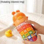 Colorful bottle with numbers and letters held by a hand, with a yellow rubber duck on a light background.