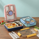 Three bento boxes with compartments filled with food on a wooden table.