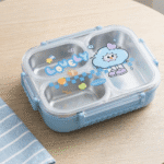 Lovely Cartoon Kids Lunch BoxStainless Steel Lunch BoxCrafty CuddleChildren's lunch box with cartoon design on a wooden surfaceBlue