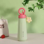 Stainless Steel Water Bottle with HandleCartoon Kids Water BottleCrafty CuddleGreen water bottle with pink lid and handle on a light green backgroundGreen