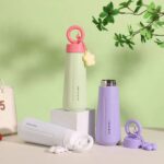Stainless Steel Water Bottle with HandleCartoon Kids Water BottleCrafty CuddleSet of colorful water bottles with pink, green, and purple designs on a light green background.White