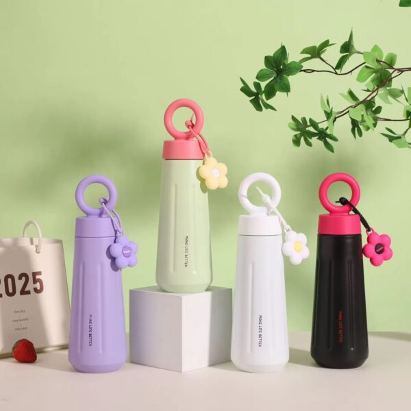 Four colorful water bottles with unique designs on a light green background