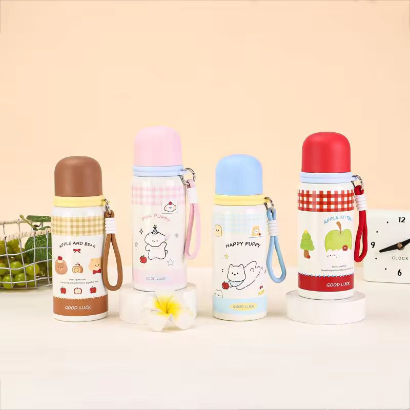 WhatsAppImage2026-03-26at5.41.23PM_3 Four colorful water bottles with cartoon designs on a beige background