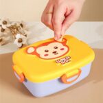 Cartoon Stainless Steel Lunch BoxStainless Steel Lunch BoxCrafty CuddleYellow lunch box with monkey design on a beige backgroundYellowkidslunchbox schoollunchbox cartoonlunchbox kidslunch schoolessentials bentolunchbox kidsproducts lunchboxforkids backtoschool tiffinbox