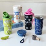 Leakproof Printed Water FlaskCartoon Kids Water BottleCrafty CuddleCollection of colorful tumblers and a small container on a white surface with a white wall background.BlueInsulatedBottle SteelWaterBottle SipperBottle LeakproofBottle TravelBottle HotColdBottle ReusableBottle DailyHydration OfficeEssentials EcoFriendlyBottle