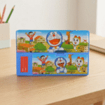 Doraemon Theme Multi - Compartment Pencil BoxPencil BoxCrafty CuddleColorful cartoon - themed pencil case on a wooden surfaceDoraemonStationery KidsPencilBox CartoonPencilCase SchoolSuppliesIndia StationeryLovers KidsSchoolEssentials PencilBoxOrganizer CuteStationery BackToSchoolIndia ReturnGiftIdeas