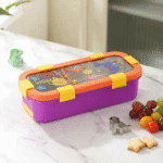 Leakproof Bento Box with Spoon ForkStainless Steel Lunch BoxCrafty CuddleColorful lunch box with a lid on a marble surfaceDinosaur