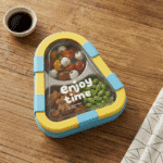 Kids 2 Compartment Lunch Box with Spoon & ForkStainless Steel Lunch BoxCrafty CuddleColorful snack container with food on a wooden table next to a small bowl of sauce.BlueKidsLunchBox BentoBox LunchBox SchoolLunch KidsEssentials LunchBoxIdeas BackToSchool LeakproofLunchBox KidsLunch TiffinBox