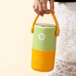 2 Layer Insulated Lunch Box with HandleStainless Steel Lunch BoxCrafty CuddleGreen and yellow lunch box with a handle held by a hand on a light backgroundGreenLunchBox TiffinBox InsulatedLunchBox LeakproofLunchBox OfficeEssentials KidsLunchBox MealPrepIndia FoodStorage LunchOnTheGo KitchenEssentials