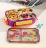 Cartoon Kids Bento Lunch BoxStainless Steel Lunch BoxCrafty CuddleColorful bento box with compartments filled with food on a desk.DinosaurKidsLunchBox LunchBox BentoBox SchoolLunch KidsLunch LunchBoxIdeas BackToSchool CuteLunchBox KidsEssentials LunchTime